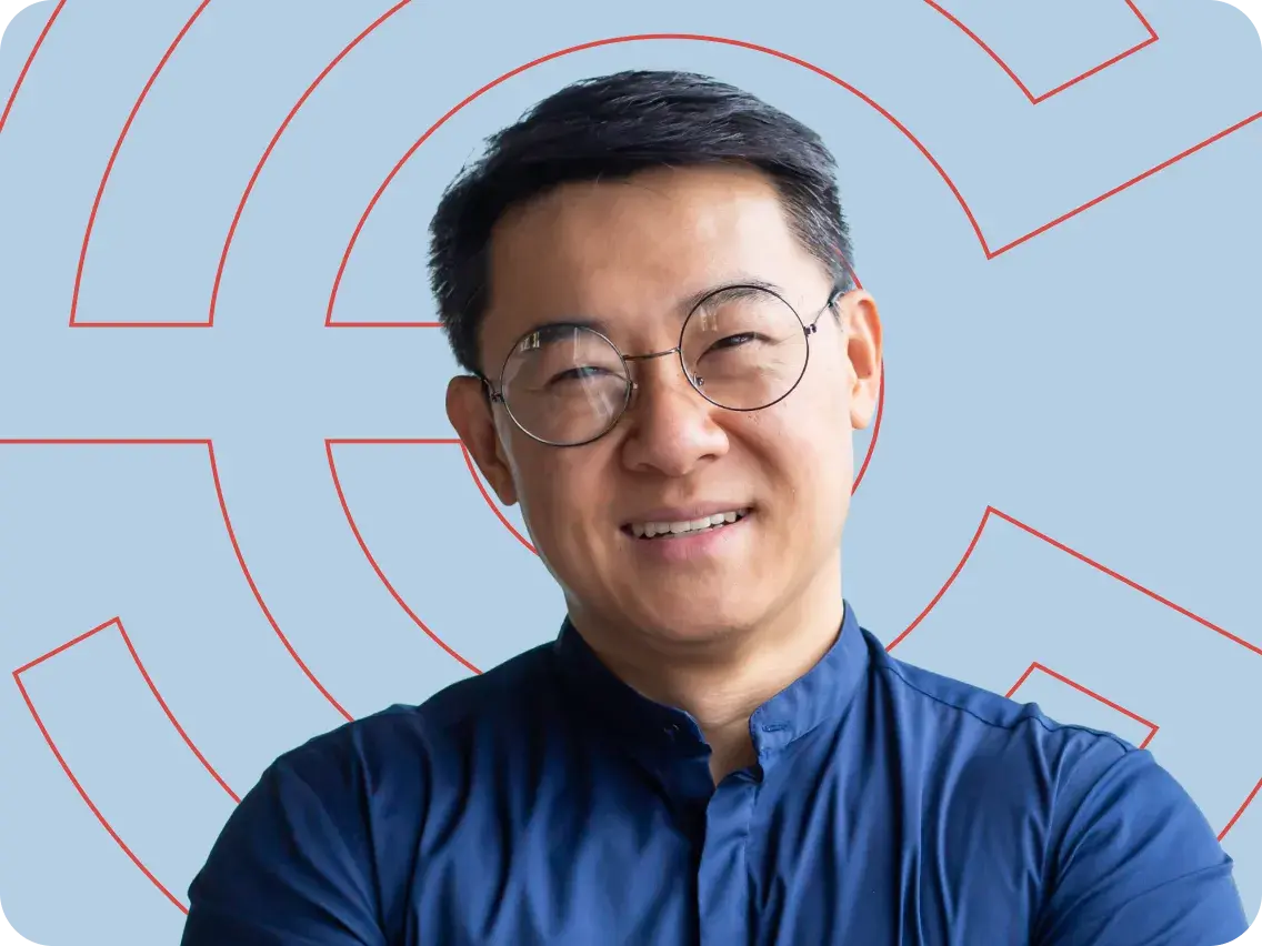 Man smiling in front of Point C branding on a light blue background.