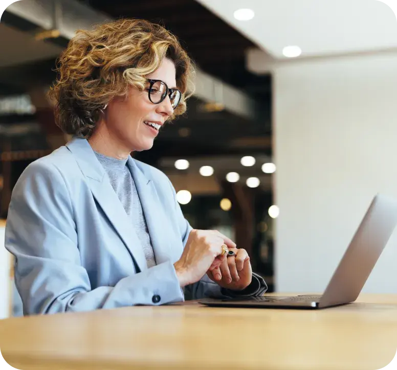 Broker working with a client at her laptop