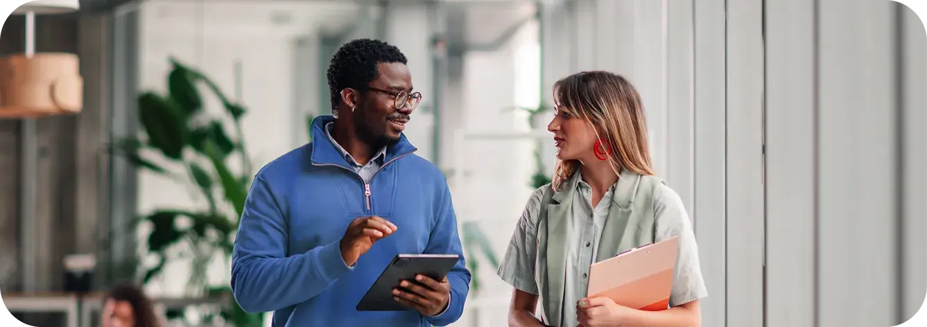 Two colleagues discussing benefits and coverage administration.