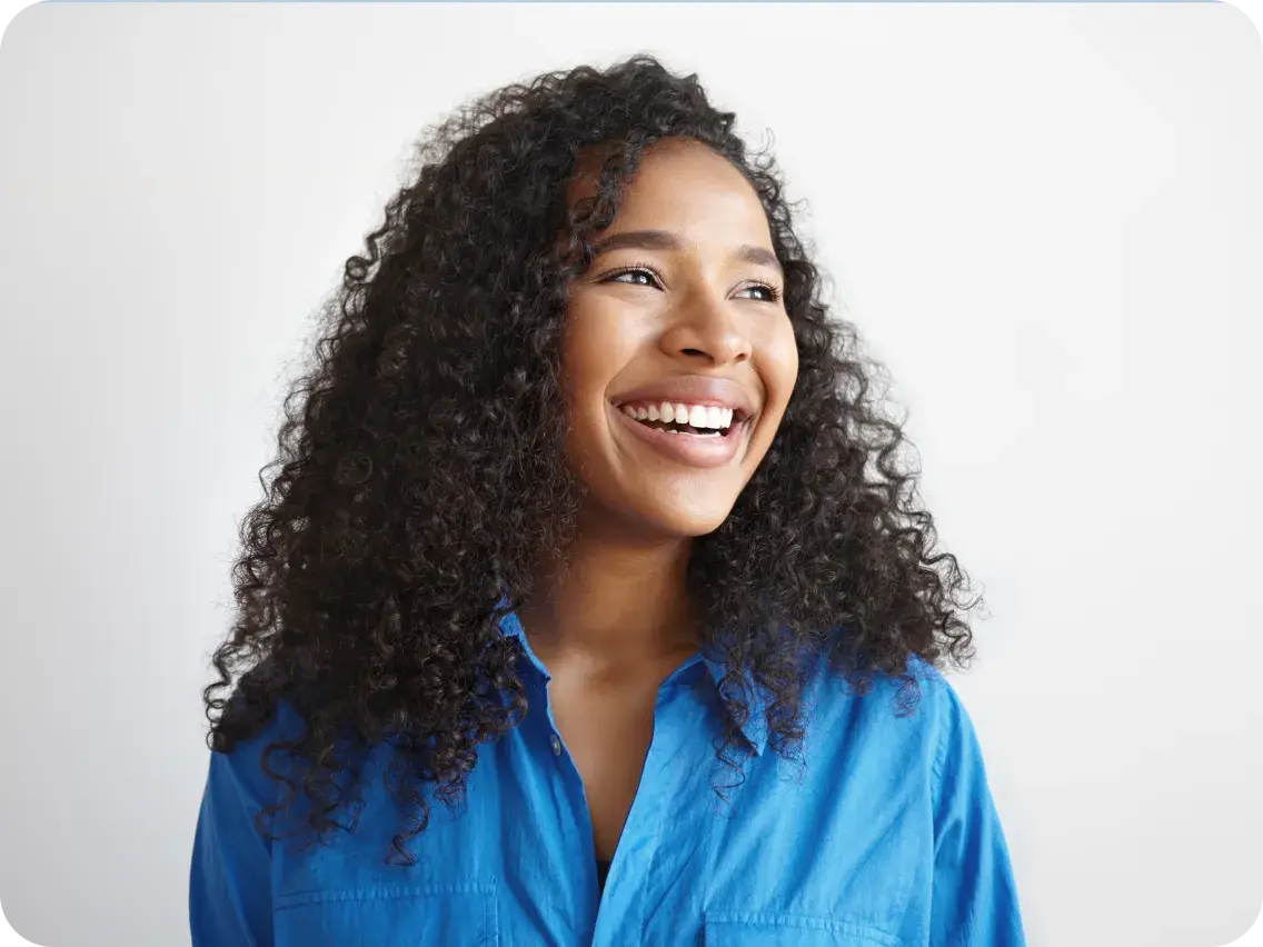 Smiling woman in a blue shirt, representing a positive employee benefits experience.
