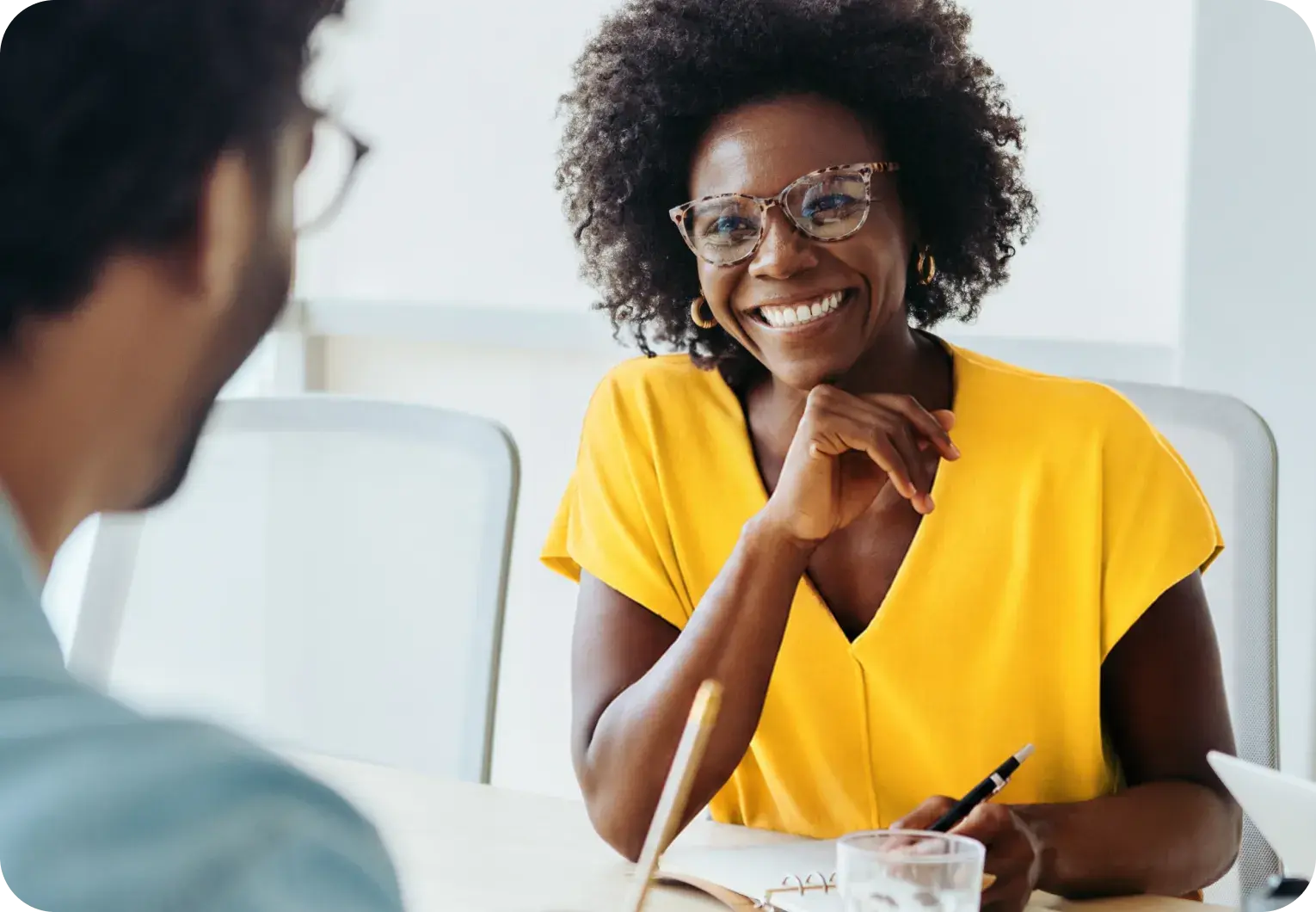 Two people discussing health plan options during a meeting.