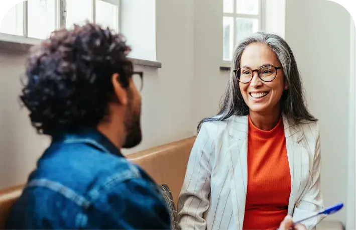 Two professionals discussing employee benefits strategy.