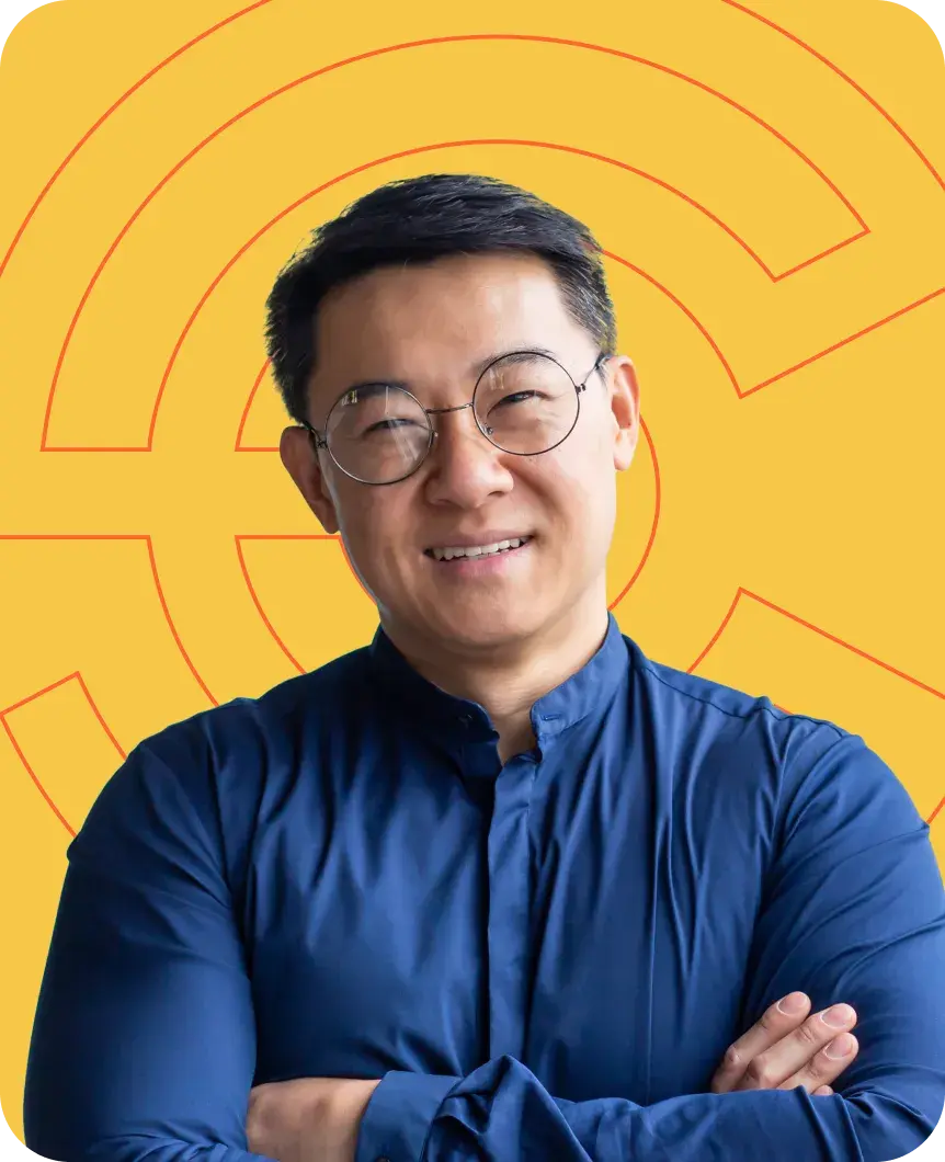 Smiling man in front of Point C branding on a gold background.