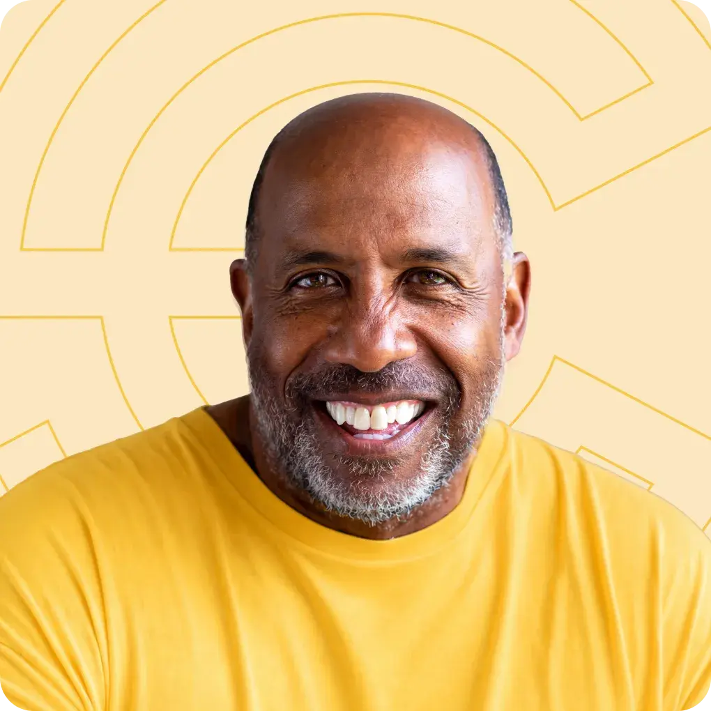 Smiling man in front of Point C branding on a yellow background.