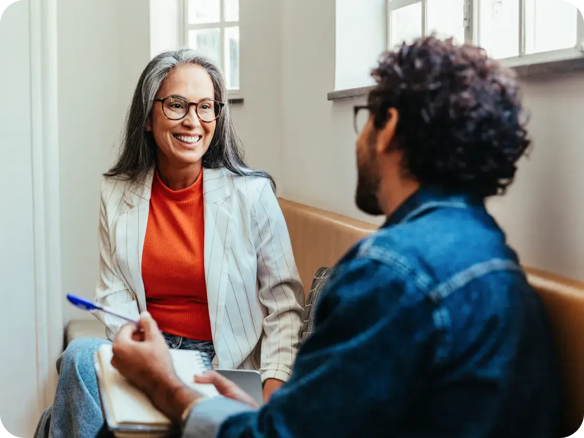Two people discussing healthcare support options during a consultation.